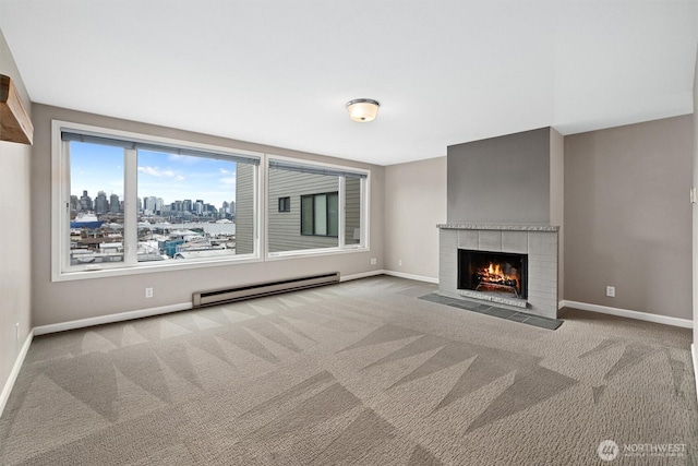 unfurnished living room featuring baseboards, a tiled fireplace, carpet flooring, a view of city, and a baseboard radiator