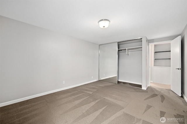 unfurnished bedroom featuring a closet, carpet flooring, and baseboards