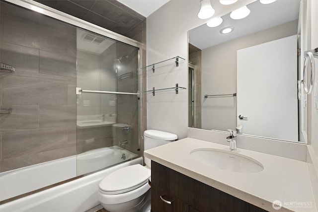 full bathroom featuring vanity, toilet, visible vents, and enclosed tub / shower combo