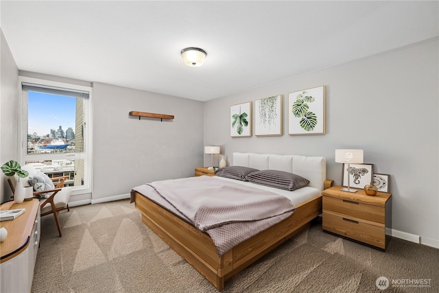 bedroom featuring baseboards and carpet floors