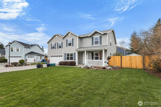 traditional-style home featuring a front lawn, fence, covered porch, concrete driveway, and an attached garage