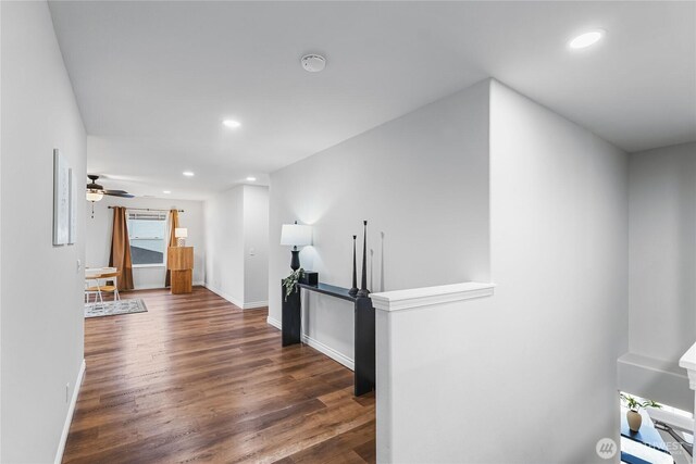 corridor featuring recessed lighting, baseboards, and wood finished floors