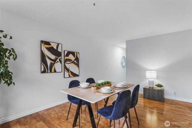 dining area with wood finished floors and baseboards