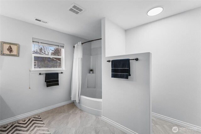 bathroom with visible vents, marble finish floor, shower / tub combo, and baseboards