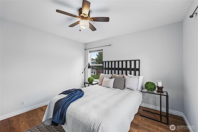 bedroom with a ceiling fan, baseboards, and wood finished floors