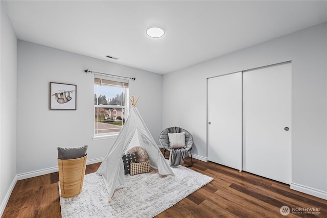 playroom featuring wood finished floors and baseboards