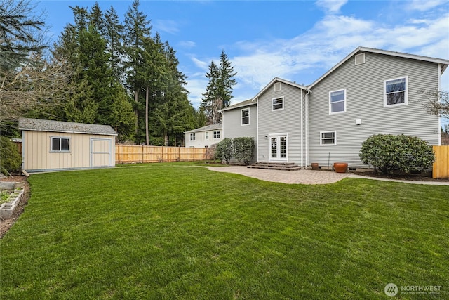 rear view of property with a yard, a fenced backyard, a patio, and an outdoor structure