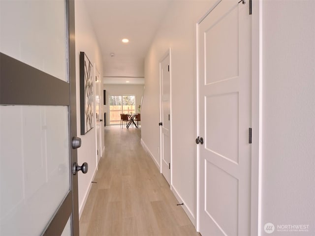 hall featuring recessed lighting, baseboards, and light wood finished floors