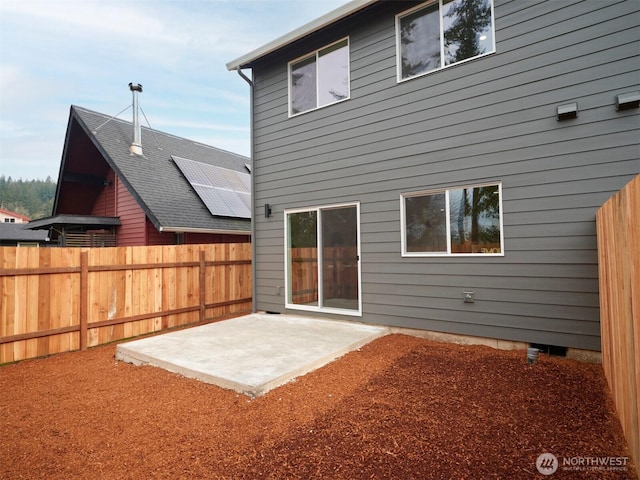 rear view of property with a patio and fence