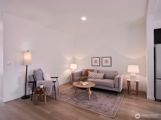 living area with recessed lighting, wood finished floors, and baseboards