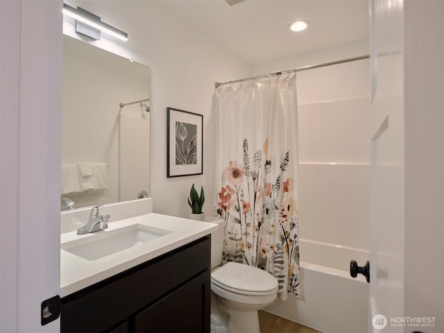 full bathroom featuring recessed lighting, shower / bathtub combination with curtain, toilet, and vanity