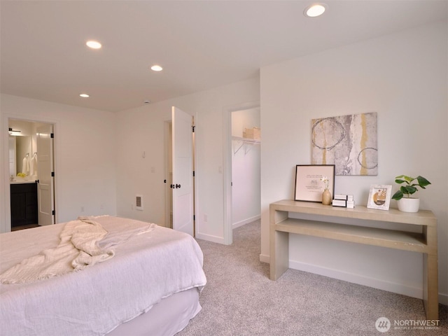 carpeted bedroom with baseboards, recessed lighting, a spacious closet, a closet, and ensuite bathroom