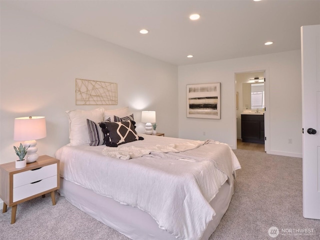 bedroom featuring carpet, baseboards, recessed lighting, a sink, and ensuite bathroom