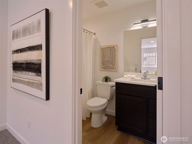 full bathroom featuring vanity, toilet, wood finished floors, and baseboards