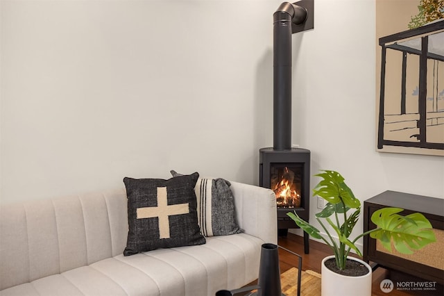 living area featuring a wood stove and wood finished floors