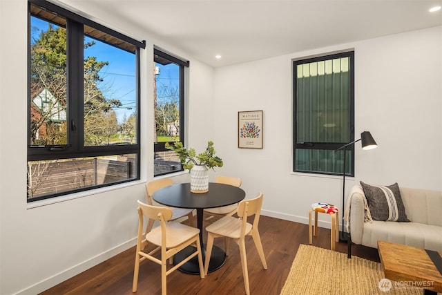 dining space featuring recessed lighting, baseboards, and wood finished floors