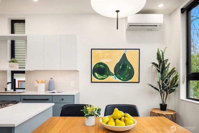 dining area with plenty of natural light, recessed lighting, and a wall unit AC