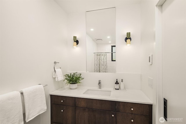 bathroom with curtained shower and vanity