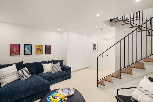 living room featuring recessed lighting, carpet, and stairs