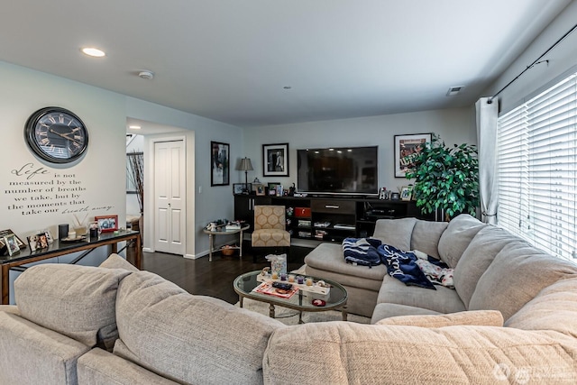 living room with dark wood-type flooring and recessed lighting