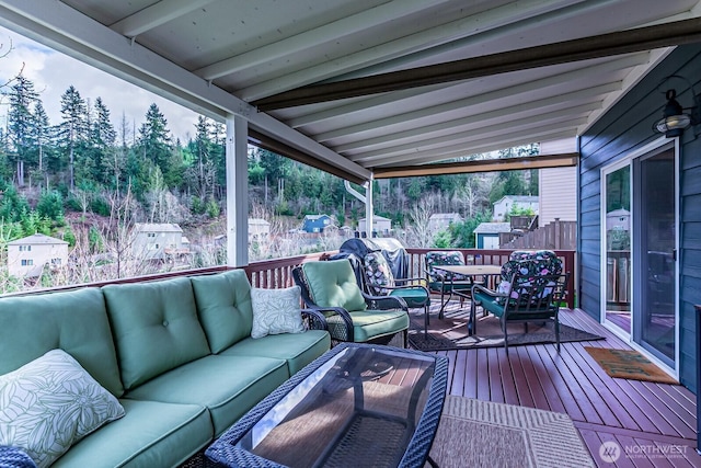 wooden deck featuring an outdoor living space and outdoor dining area