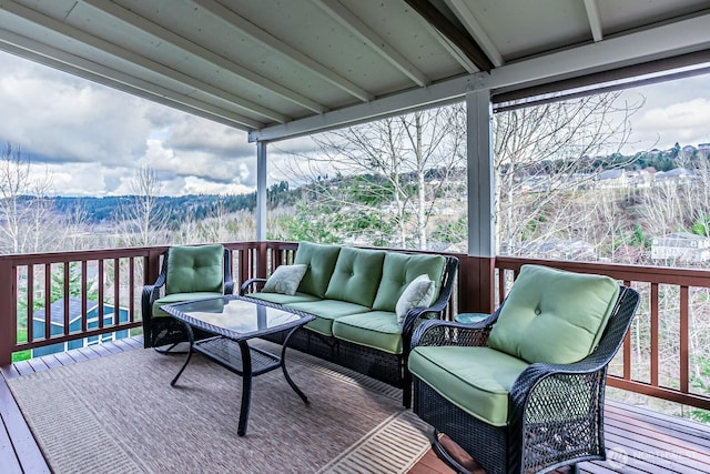 wooden deck featuring a mountain view, a view of trees, and outdoor lounge area