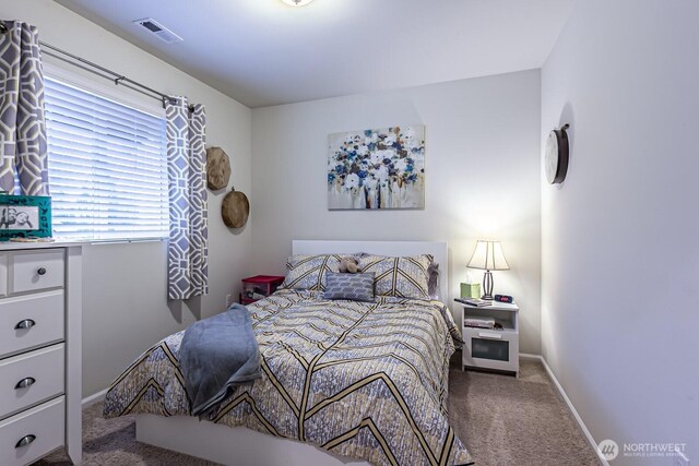 carpeted bedroom with visible vents and baseboards