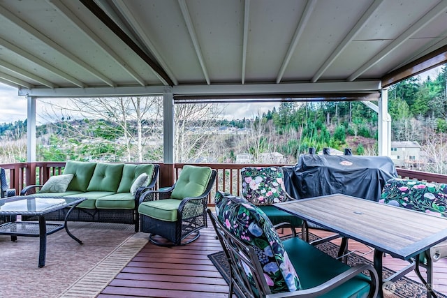 wooden terrace with area for grilling and an outdoor hangout area