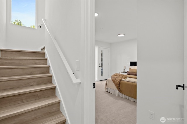 staircase with recessed lighting and carpet floors