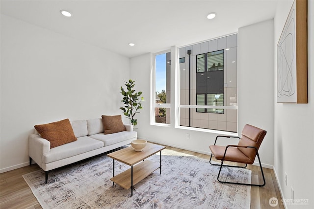 living room featuring recessed lighting, wood finished floors, and baseboards