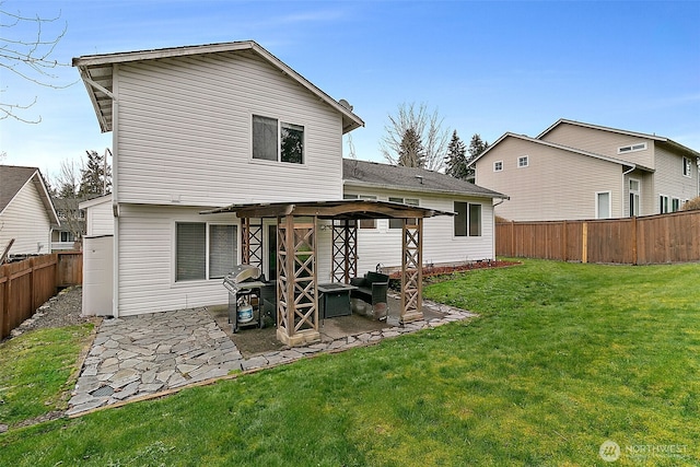 back of property with a patio area, a fenced backyard, and a yard