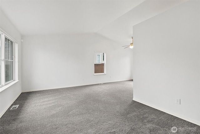 carpeted spare room with visible vents, baseboards, and vaulted ceiling