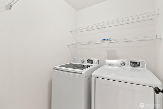 clothes washing area featuring laundry area and washing machine and dryer