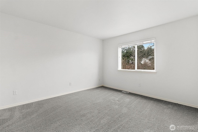 carpeted empty room featuring visible vents and baseboards