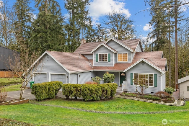 traditional home with a front yard, an attached garage, and crawl space