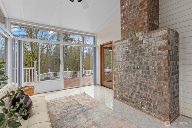 unfurnished sunroom featuring lofted ceiling and ceiling fan