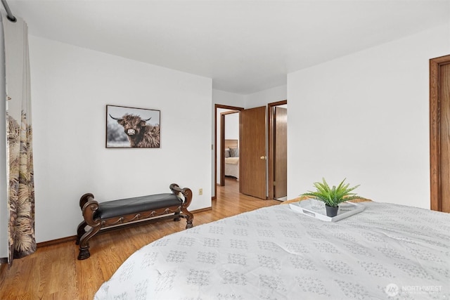 bedroom with baseboards and light wood-style flooring