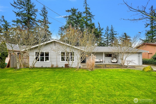 view of front facade with driveway, a front yard, and a garage