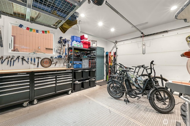 garage with a workshop area and a garage door opener