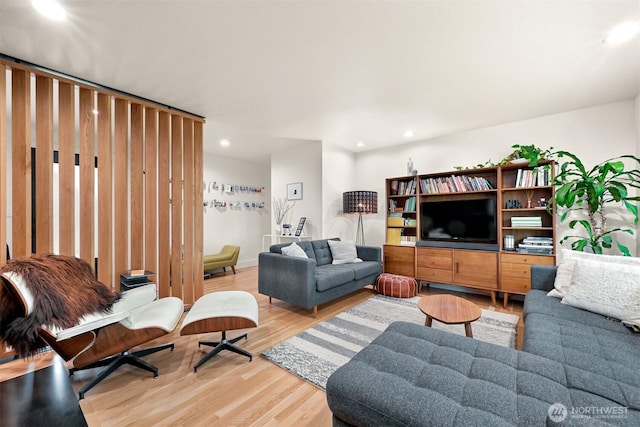 living area with recessed lighting and light wood-style flooring