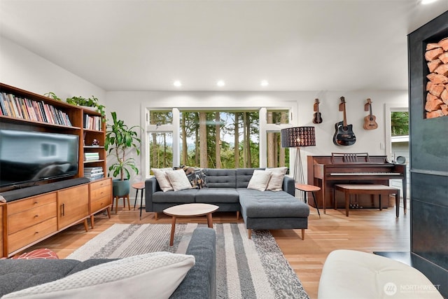 living area featuring recessed lighting, a healthy amount of sunlight, and wood finished floors