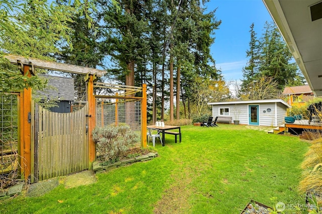 view of yard with an outdoor structure and fence