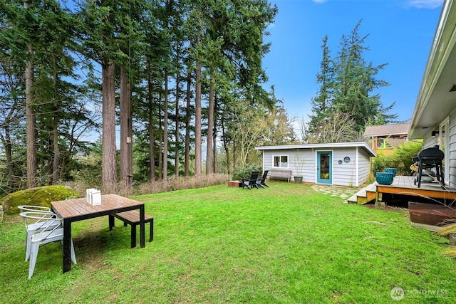 view of yard featuring an outbuilding and a wooden deck