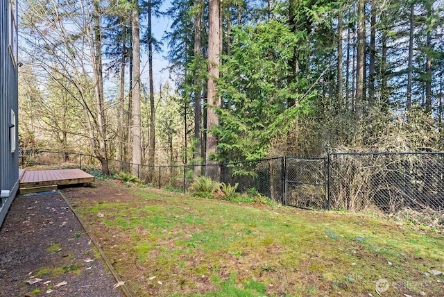 view of yard with a wooden deck and fence