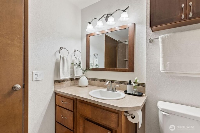 bathroom with toilet and vanity