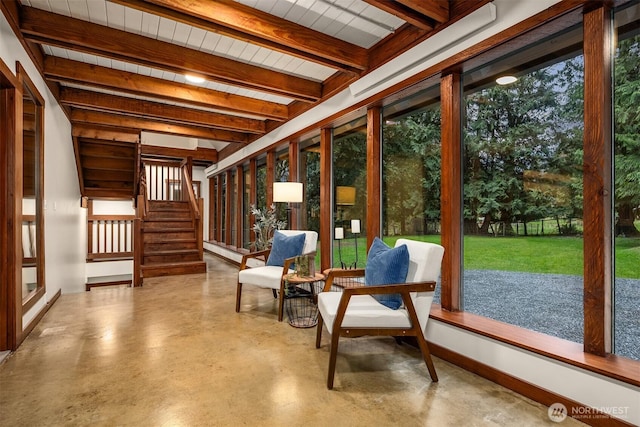 sunroom featuring beam ceiling
