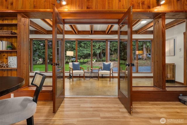 sunroom featuring french doors and beamed ceiling