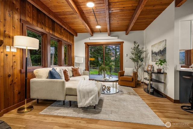 sitting room with wooden ceiling, baseboards, light wood-style floors, and beamed ceiling