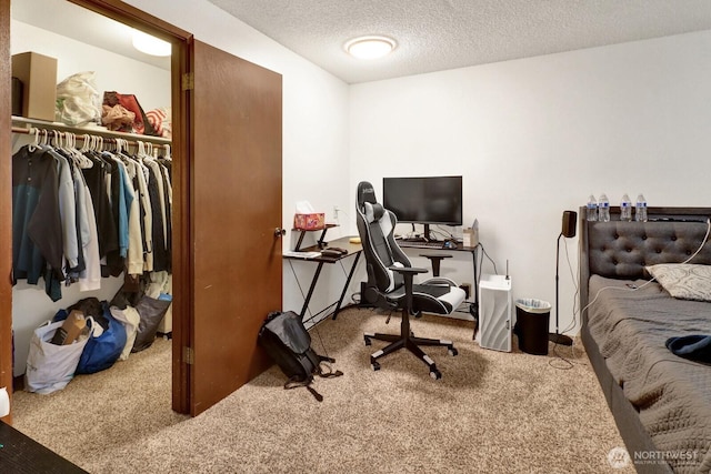 carpeted bedroom with a closet and a textured ceiling