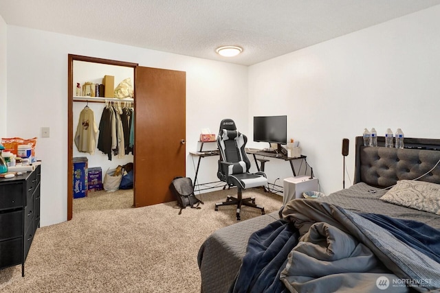 carpeted bedroom with a closet and a textured ceiling